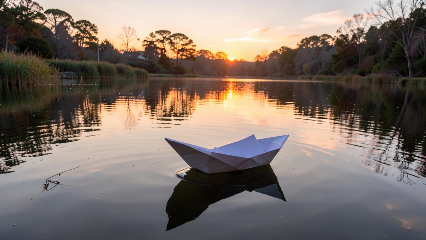 flux.2 Klein 4B output: A paper boat drifting across a quiet pond at sunrise.